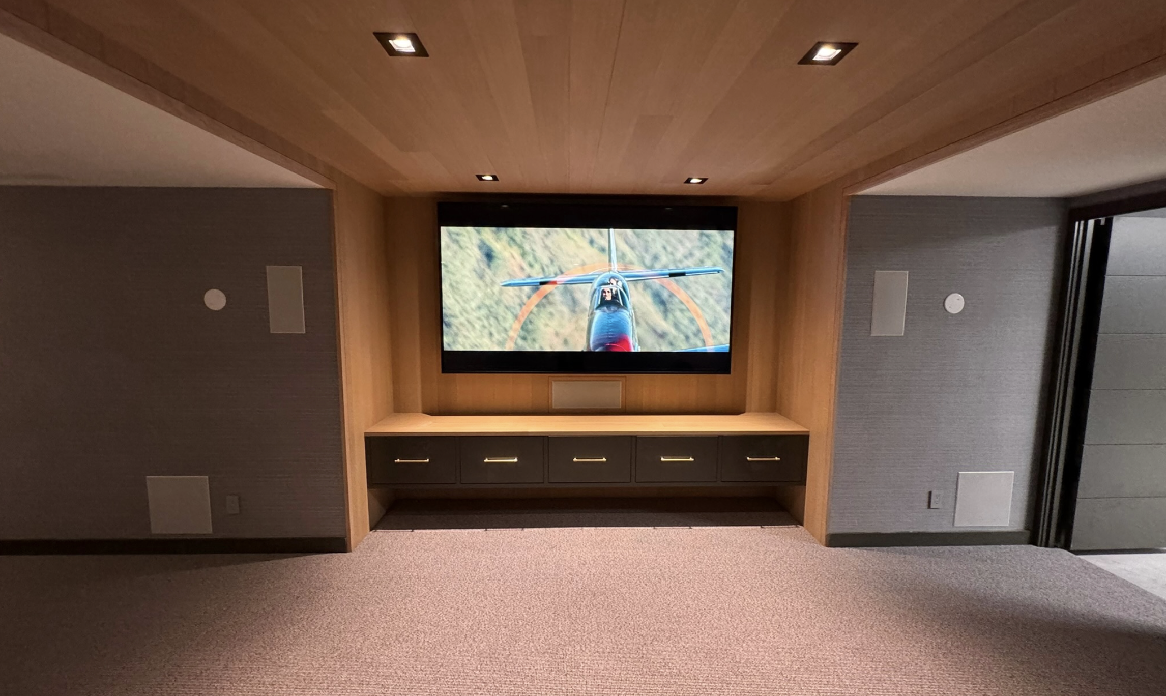 Modern media room with large display and comfortable seating in a Martha's Vineyard home