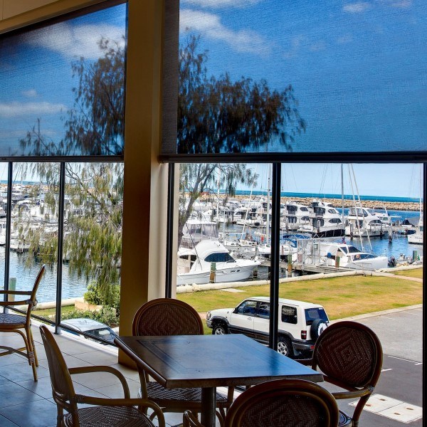 Outdoor motorized patio shades on a covered deck