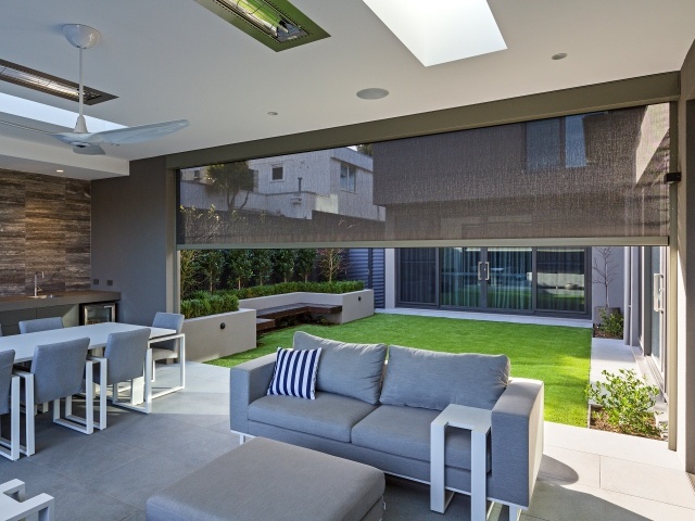 Motorized roller shades in a modern living room