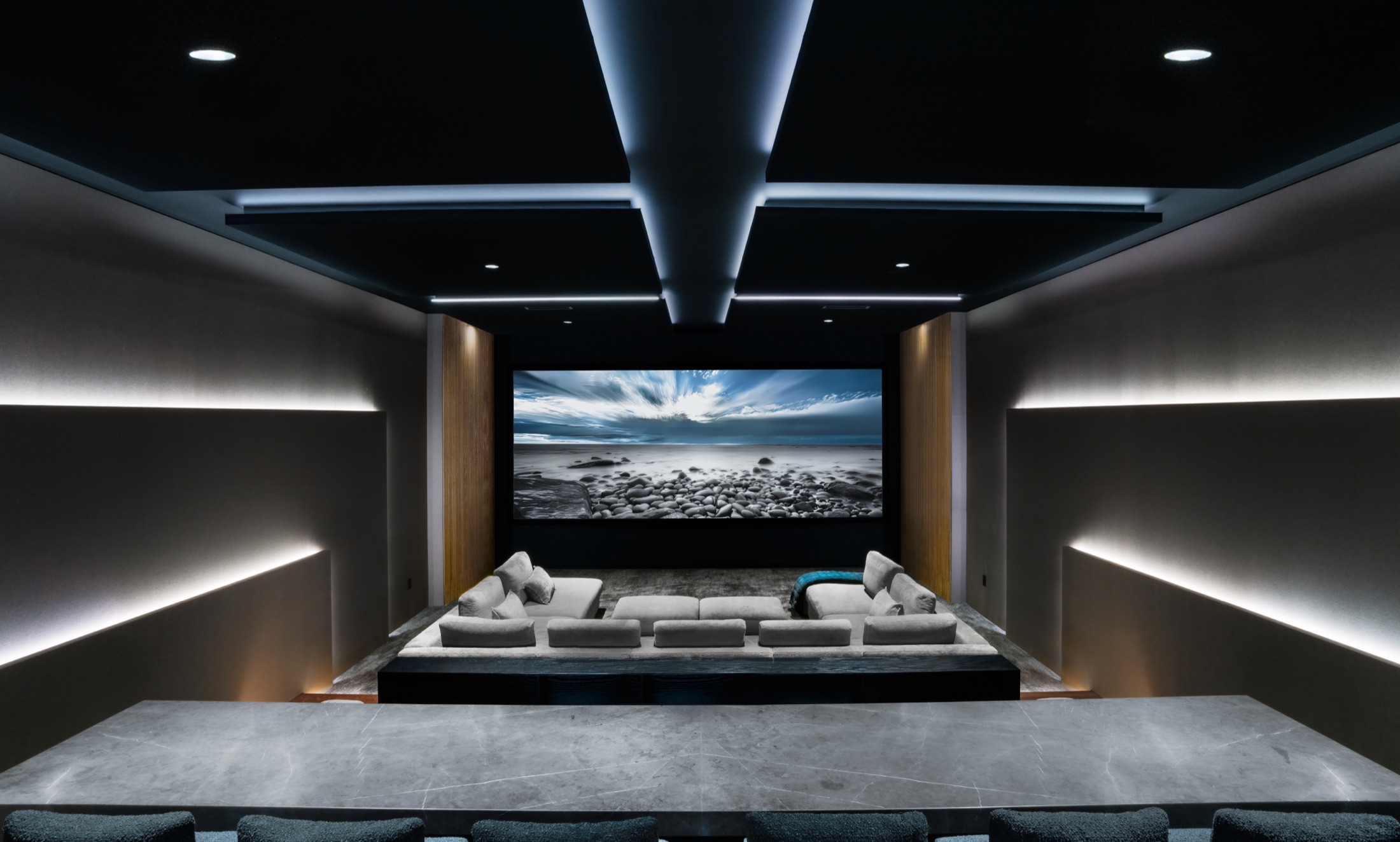 Elevated symmetric view over the theater bar toward the screen