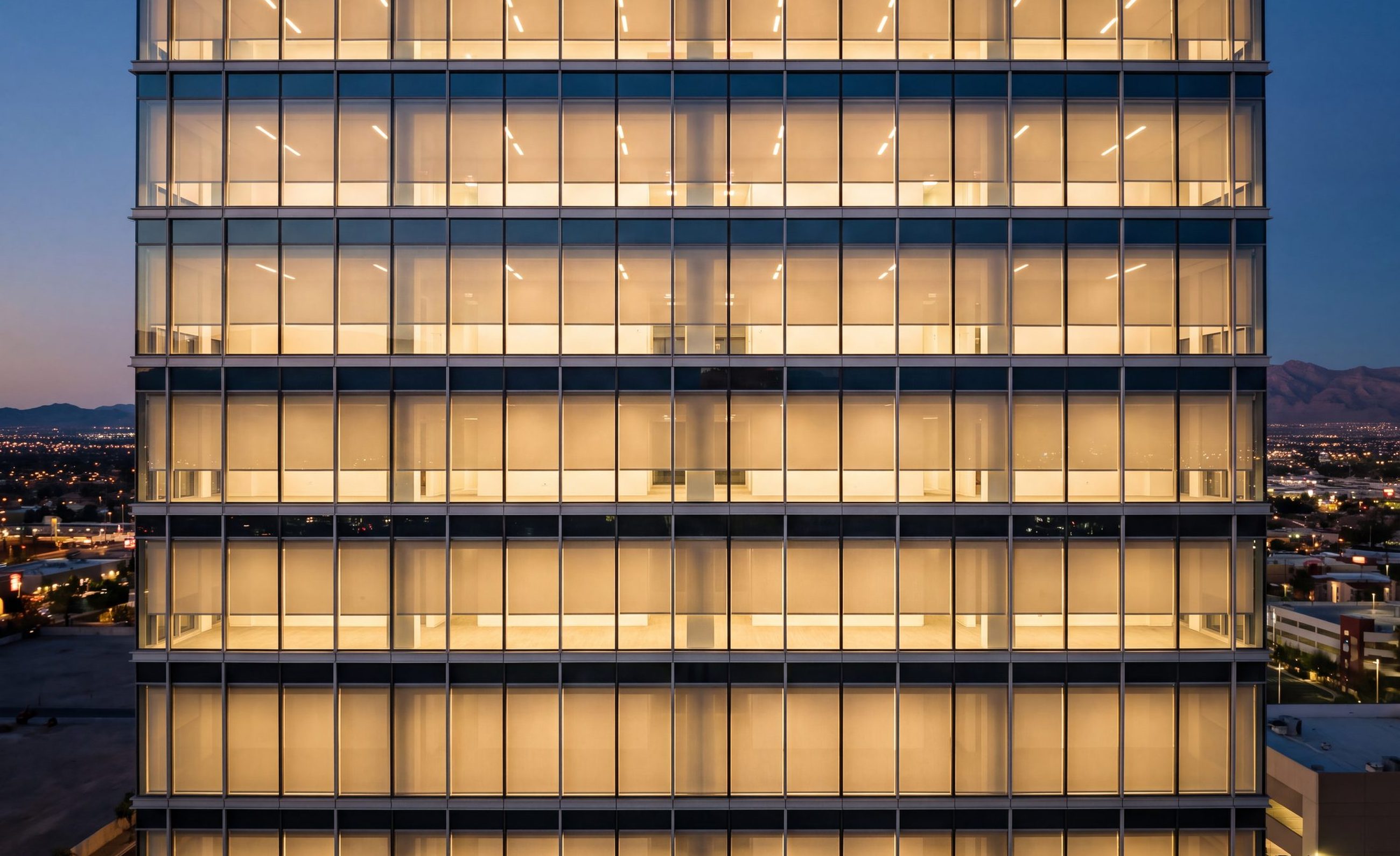 A Las Vegas tower in the evening, interior shades level on every floor