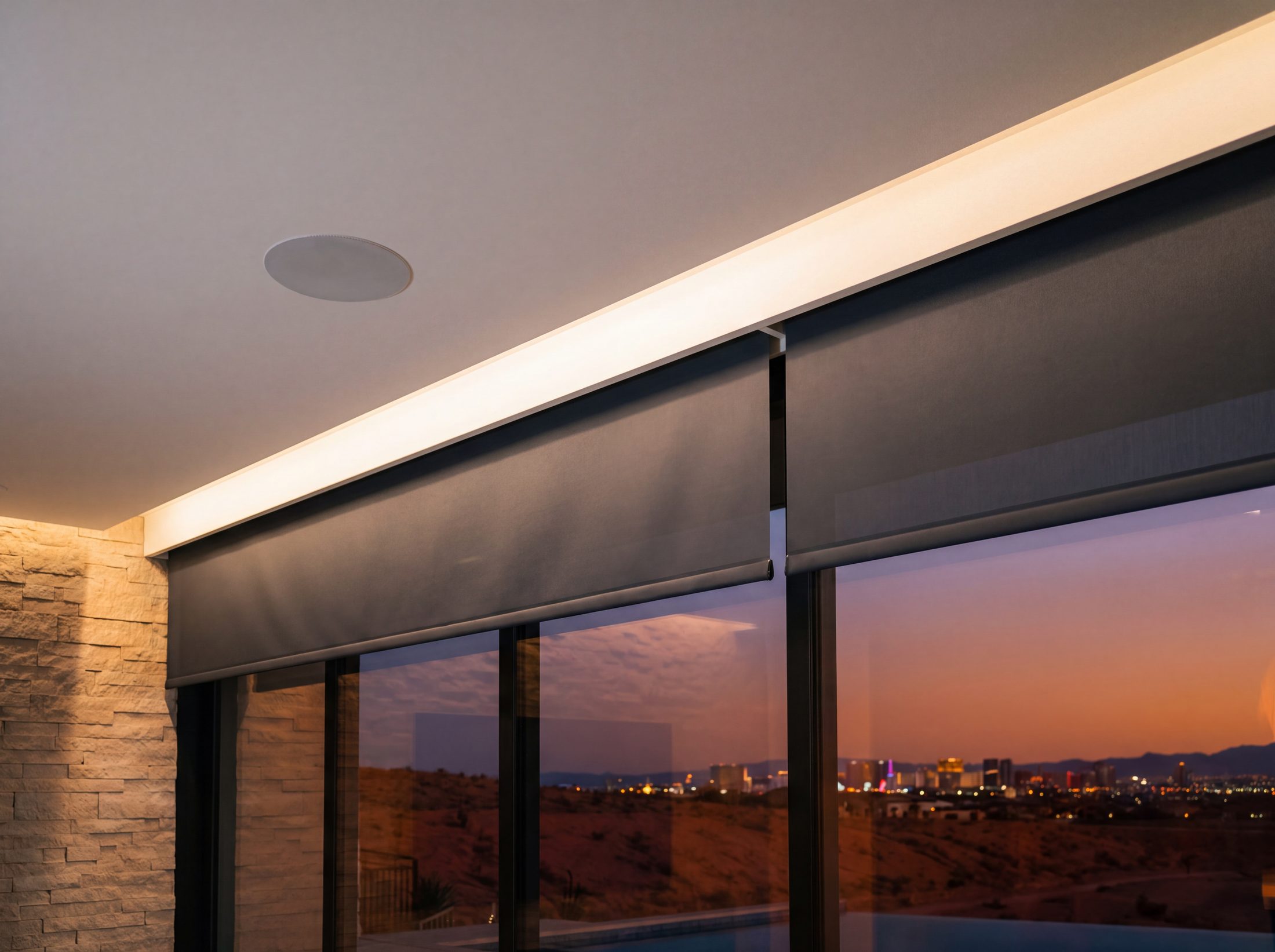 The glazing head where the shade pocket, the cove and a flush speaker share one reveal line