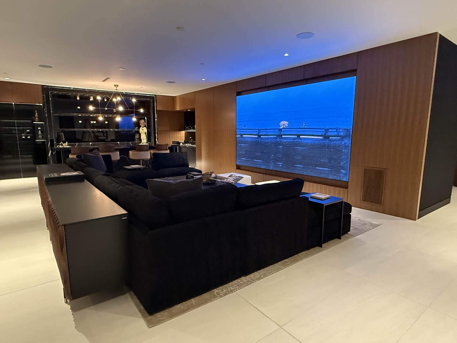 The lounge from the bar, seating and screen on one axis