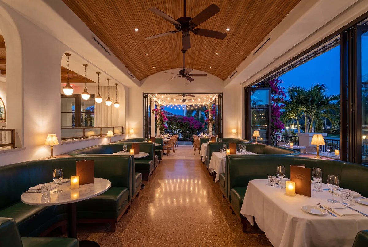 Restaurant dining room, pendants and table lamps, doors open to the terrace.