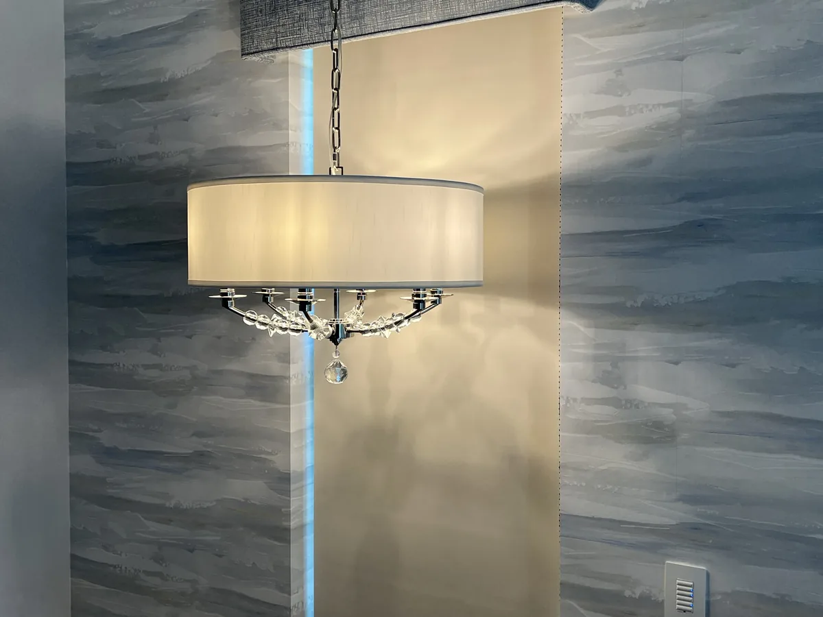 Pendant against a textured feature wall.