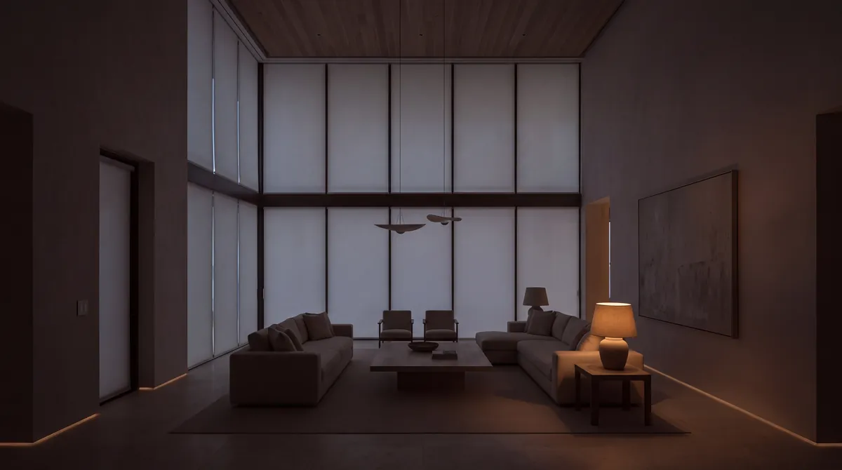 The same room at night, the shades fully down, a lamp and the toe-kick light on