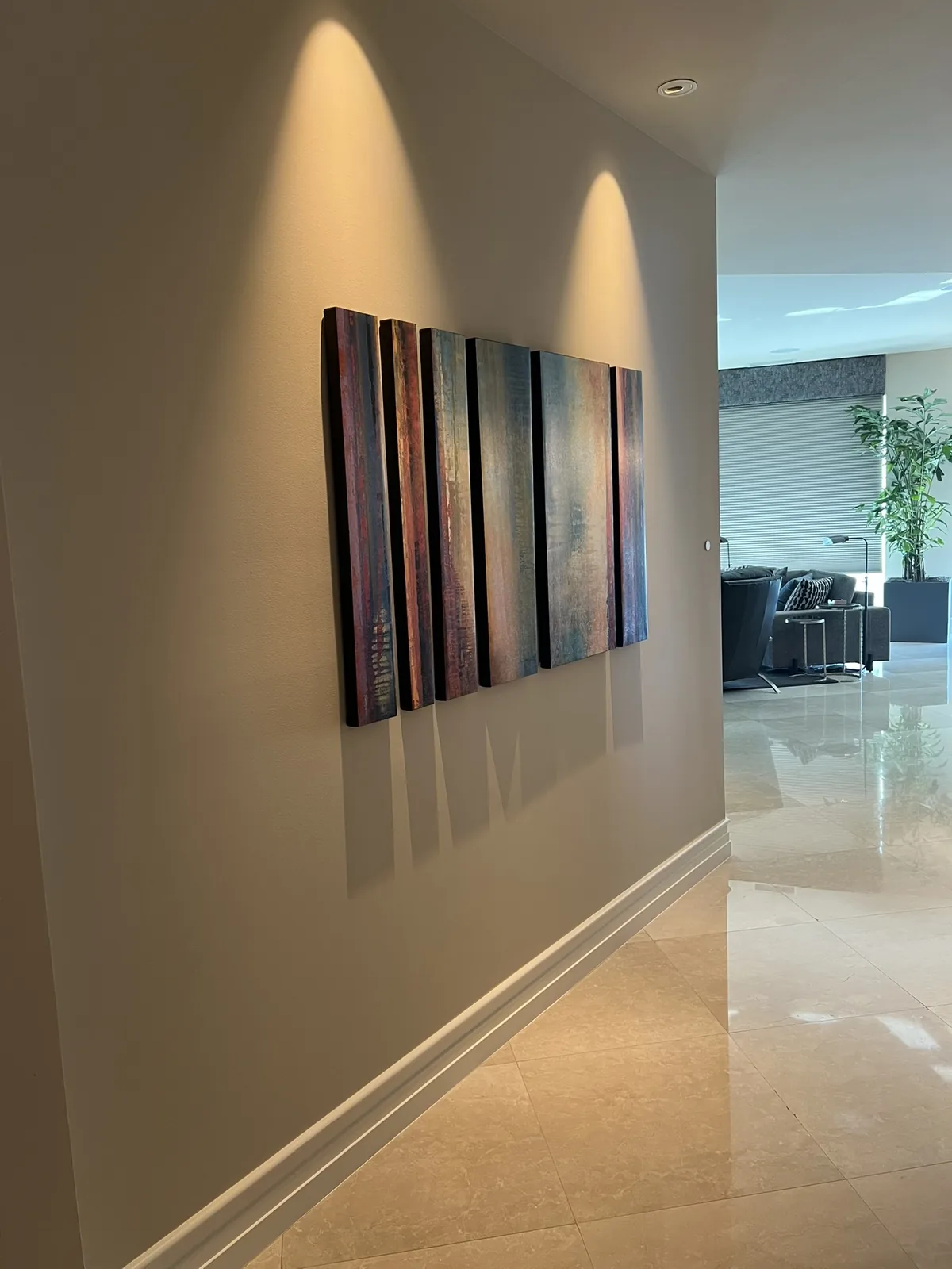 A single art panel, washed along the length of a corridor.