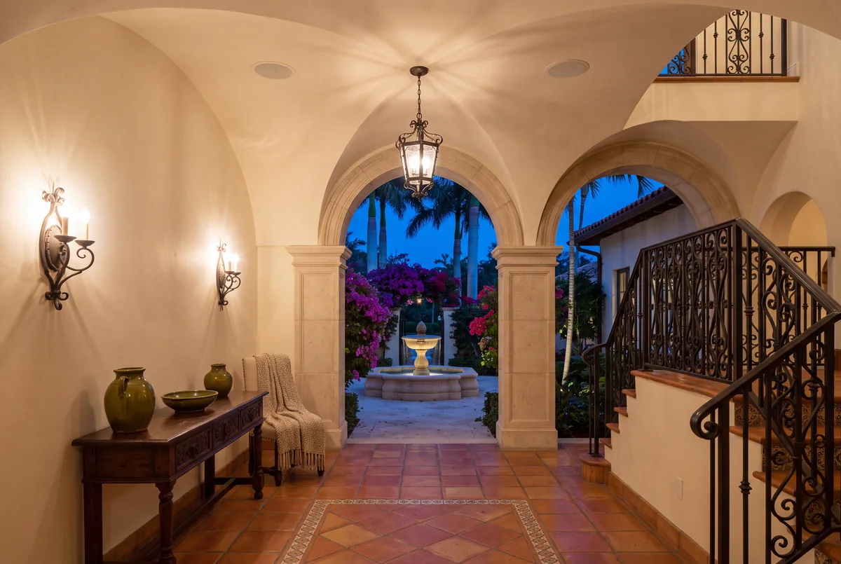 Mediterranean entry hall, lantern and sconces on one scene.